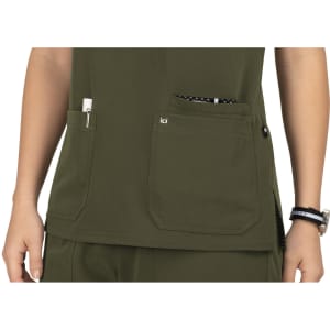 An olive green top with two front pockets, featuring a logo and a patterned lining visible in one pocket.