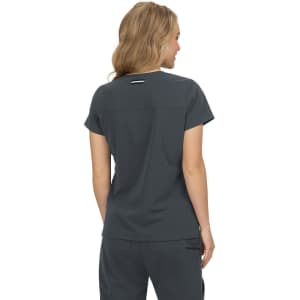 A short-sleeve top in dark grey, featuring a logo, displayed from the back on a model.