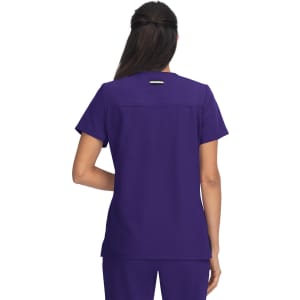 A back view of a woman wearing a purple top with a logo on the back. The fabric appears smooth and professional.