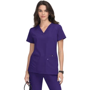 A woman wearing a purple scrubs top with a V-neck and pocket, accompanied by a stethoscope.