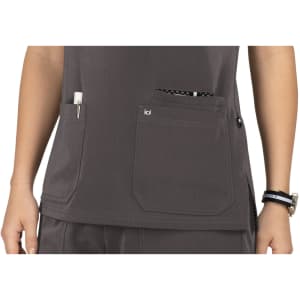A grey top featuring multiple pockets, including a chest pocket and a larger bottom pocket, with a logo on one.