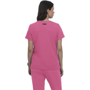 A pink top designed for comfort, featuring a simple back design and a logo on the upper back.