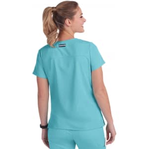 A turquoise top with short sleeves and a simple design, featuring a logo on the back.