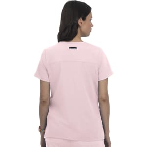 A pink top featuring short sleeves and a back design, with a brand logo on the upper back.
