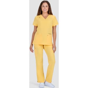 A woman wearing a bright yellow scrub top and matching pants, standing against a neutral background.