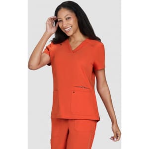 An orange top featuring a V-neckline and two front pockets, worn by a smiling woman.