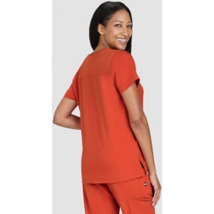 A top in vibrant orange with short sleeves and a relaxed fit, featuring a back panel detail.
