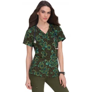 A floral print scrub top featuring dark brown and green hues, worn by a model with a stethoscope.