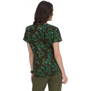 A floral print top featuring green and blue flowers on a dark background, with short sleeves and a casual style.
