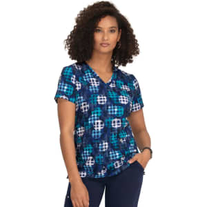 A patterned top featuring blue hues and a graphic design, with short sleeves and a V-neckline.
