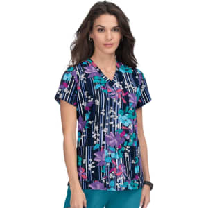 A floral print scrub top in navy, featuring pink, purple, and white flowers, with a V-neck and short sleeves.