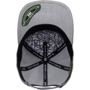 A grey cap featuring a modern design and an internal patterned lining, with a logo displayed inside.