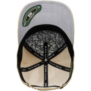 A grey and beige 5 panel cap with an interior patterned lining and a logo on the underside of the peak.
