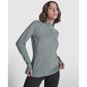A half zip sweatshirt in a soft green colour, featuring a slim fit and a logo on the sleeve.