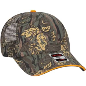 A 6 panel trucker hat in a camo pattern with yellow leaves and a mesh back, featuring a branded logo.