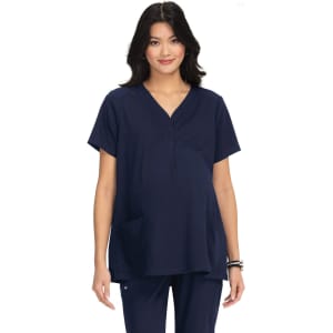 A maternity top in navy blue, featuring a V-neck design and a front pocket, worn by a model.
