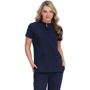 A navy blue medical scrub top worn by a model, featuring a collar and two front pockets. The top is paired with matching pants.