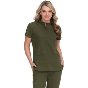 A green medical scrub top featuring a short collar and two front pockets, worn by a woman.