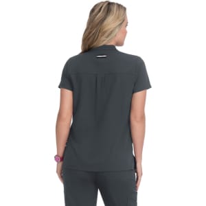 A woman is wearing a short-sleeved, dark grey shirt, viewed from the back. The shirt has a logo on it.