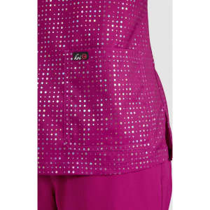 A vibrant fuchsia top featuring a pocket, adorned with a pattern of reflective dots, with a logo present.