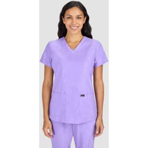 A purple scrub top with a V-neck design, featuring a subtle pattern and a logo on the front.