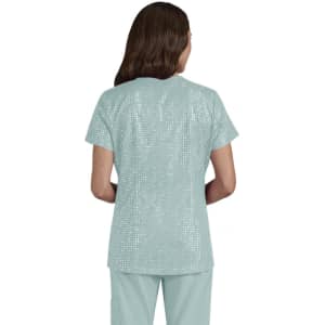 A top in a light teal colour with a textured pattern, viewed from the back, featuring short sleeves.