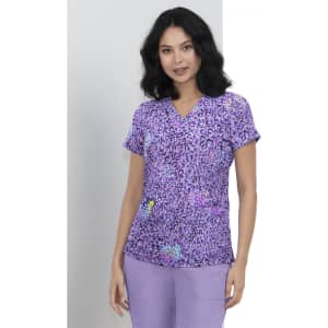 A purple printed top featuring a leopard pattern, with a woman wearing it and posing against a light background.