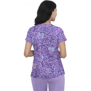 A woman wearing a purple leopard-print top with short sleeves, viewed from the back. The top features various shades of purple.