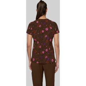 A floral print top in brown, featuring pink and purple flowers, viewed from the back on a model.