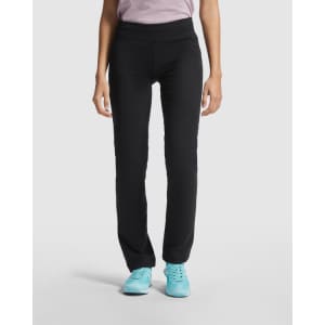 Black straight-cut leggings with a wide waistband, paired with blue sports shoes. A model stands with hands at sides.