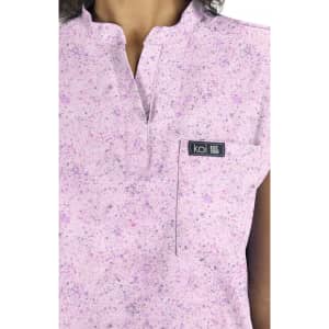 Ari Top (Print) in a pink, speckled pattern with a small pocket and branding tag.