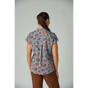 A short-sleeved top featuring a vibrant print with various colours and patterns, viewed from the back.