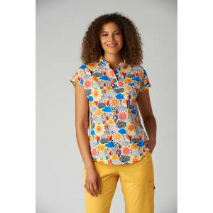 A floral-patterned short-sleeve top featuring blue, yellow, and red colors, worn by a woman with curly hair.