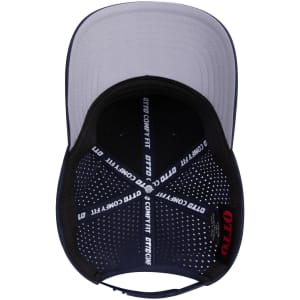 A navy and grey 6 panel mid-profile perforated baseball cap with an inner lining featuring a logo.