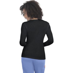 A long-sleeve tee in black, featuring a patterned design on the back and casual fit with a rounded neckline.