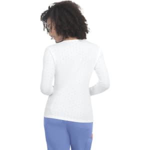 A white long-sleeve tee with a textured pattern, featuring a back view and a curved hem.