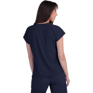 A navy top with a relaxed fit, featuring a back view of a woman wearing it. The garment has short sleeves and a subtle brand logo.