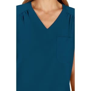 A V-neck top in a deep teal colour featuring a pocket on the left side. The fabric has a smooth finish.