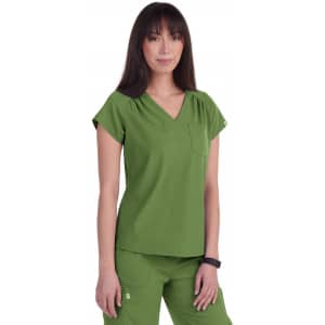A green scrubs top with a V-neck and short sleeves, featuring a pocket on the front. The model stands confidently.
