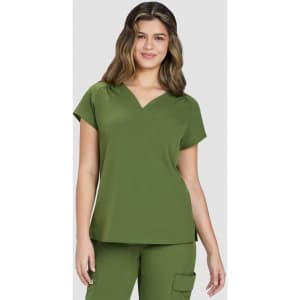A green top with a V-neck and short sleeves, featuring a pocket on the front. The model is smiling.