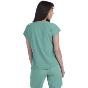 A teal top with short sleeves, featuring a smooth finish, displayed on a model from the back. The top has branding.