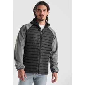 A jacket featuring a quilted grey body with black sleeves and a zip front. It has a logo on the side.