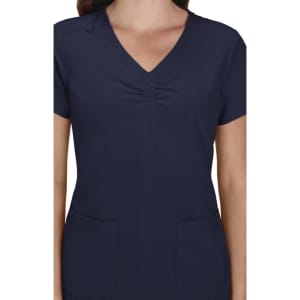 A women's navy blue scrub top featuring a V-neck and short sleeves with two front pockets and a gathered detail.