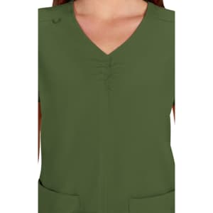 A close-up of a green scrub top featuring a v-neck design and gathered detailing at the front.
