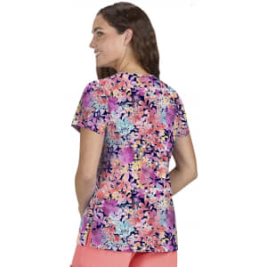 A floral print women's top featuring vibrant colours like pink, purple, and blue, with a relaxed fit and short sleeves.