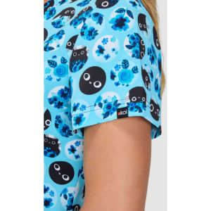 A top featuring a blue floral print with black circular designs and faces, showcasing vibrant shades of blue. It has a logo.
