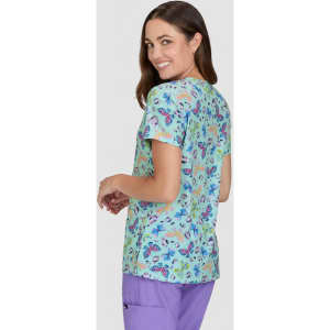 A top featuring a vibrant floral print in shades of blue and pink, with a relaxed fit and a logo on the sleeve.
