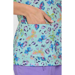 A top featuring a light turquoise background with colourful butterfly and animal print designs, including a pocket.
