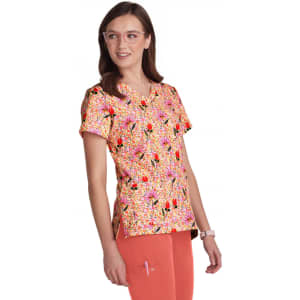 A vibrant pink and multi-coloured floral print top with short sleeves, paired with coral pants.
