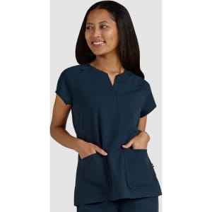 A navy blue medical top with short sleeves, featuring front pockets and a small logo.
